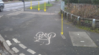 Milton Road Cycle Path - Near Kendal Way - Photo with arrows pointing to remnants of white paint. 